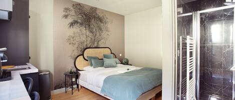 Laptop workspace, iron/ironing board, bed sheets