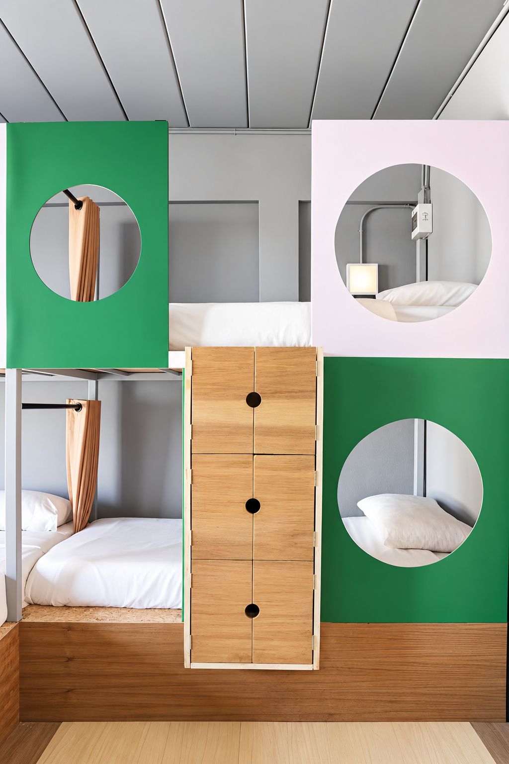 A bunk bed with a wooden headboard, a green wall with circular cutouts, and a bedside table with a lamp.