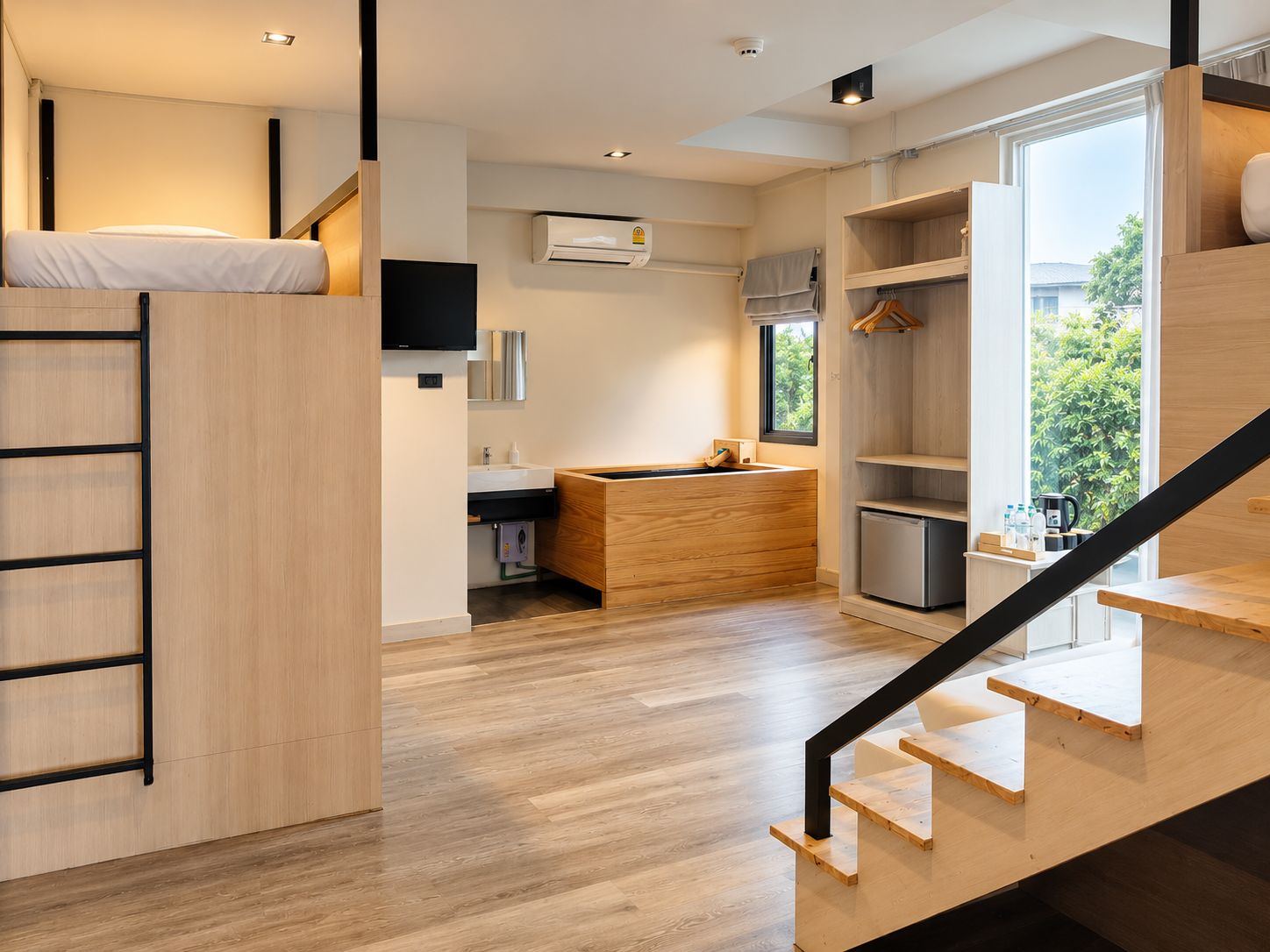 Una cocina moderna y funcional con estufa integrada, un lavamanos y una ventana que ofrece vistas al exterior.