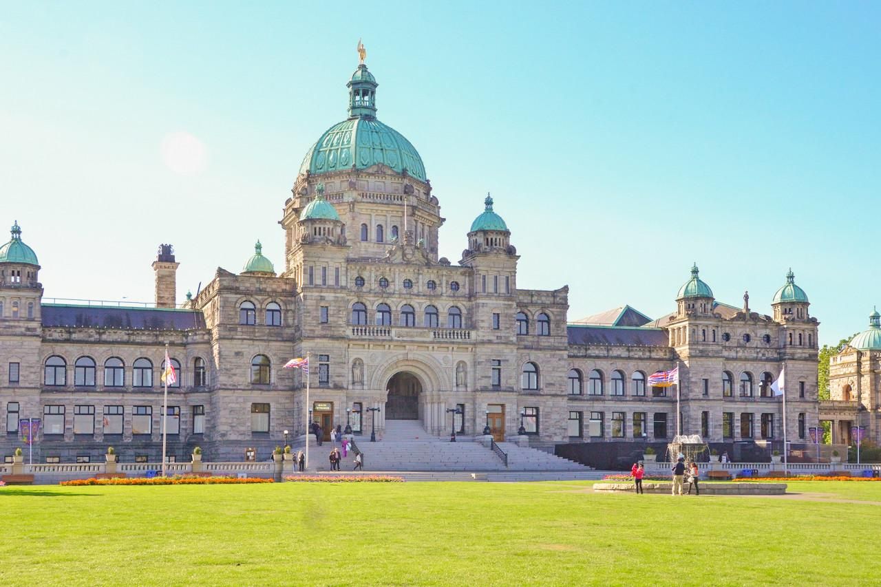 A large, historic building with a prominent dome and multiple smaller domes, featuring a grand entrance and a well-maintained lawn.