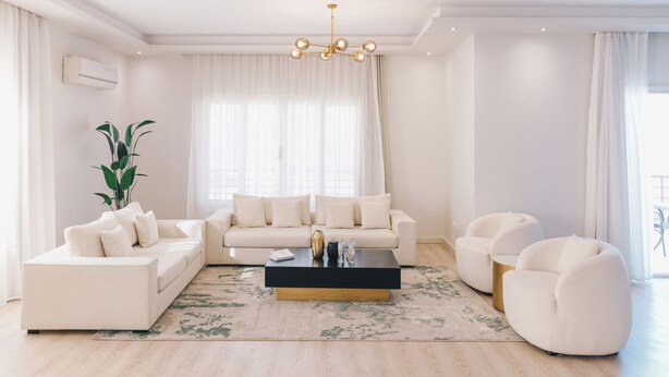 A modern living room with a sofa set, a coffee table, and a chair. - The Seven Six Near Waterway 5A - 3, THE SEVEN SIX near WATERWAY 5A MALL By ELEGANT (New Cairo City)