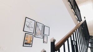 A staircase with black railings and a wooden handrail, leading to an upper floor. - The Seven Six Near Waterway 5A - 10, THE SEVEN SIX near WATERWAY 5A MALL By ELEGANT (New Cairo City)
