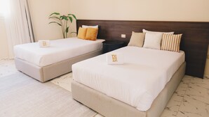 A hotel room with two beds, a nightstand, a potted plant, and a marble floor. - VIDA in Yasmeen - V302, VIDA Garden View Apartment (New Cairo City)