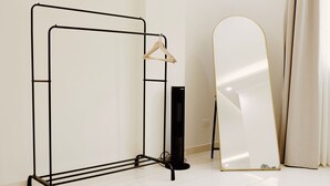 A room with a metal wardrobe, a full-length mirror, and a hanging clothes rack. - VIOLA Near Waterway - 21, VIOLA New Studio - Higher Floor (New Cairo City)