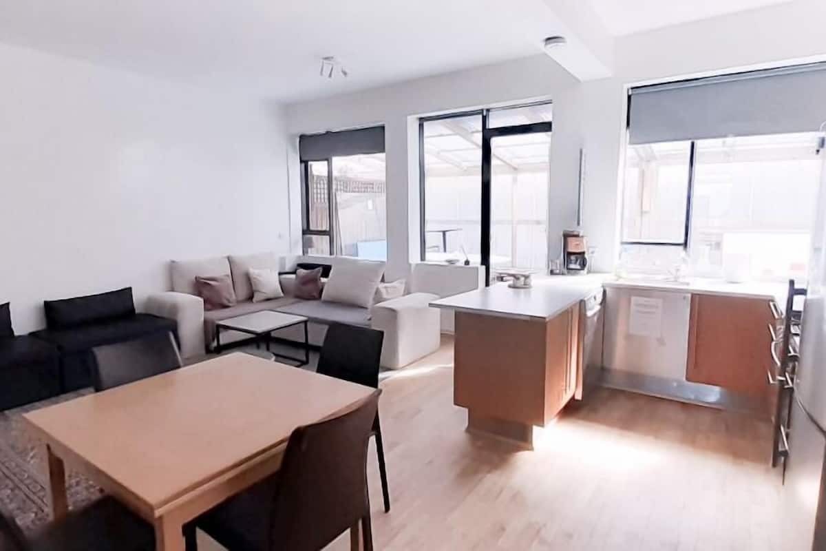 A modern apartment with a living area, dining space, and kitchen.
