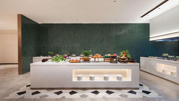 A modern kitchen with a central island, equipped with various food items and utensils. - Hilton Garden Inn Chengde Mountain Resort (Chengde)