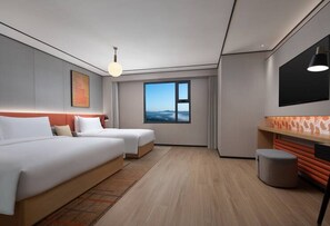 A modern hotel room with two beds, a large window, a TV, and a small seating area. - Hilton Garden Inn Chengde Mountain Resort (Chengde)