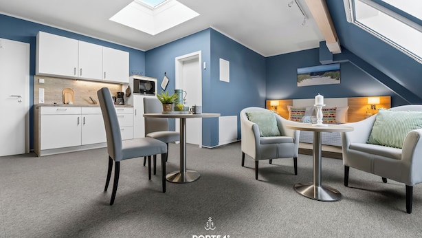 A modern interior with a dining area, kitchen, and seating space.