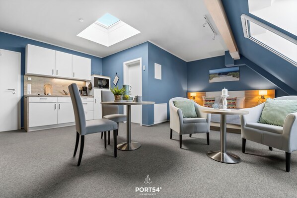 A modern interior with a dining area, kitchen, and seating space.