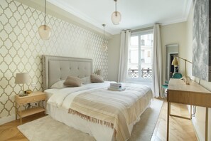Laptop workspace, iron/ironing board, bed sheets - Sublime Apartment Haussmann Opera (Paris)