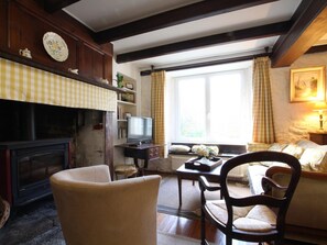 A cozy living room with a fireplace, a television, and a comfortable seating area.