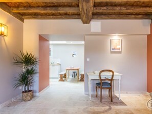 Cozy retreat with a desk for work and a kitchen area for meals.