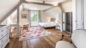 A bedroom with a bed, a chair, a dresser, and a colorful rug. - Blueberry of the Valley - House With Swimming Pool (Saint-Pierre-Azif)