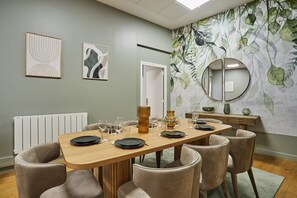 Enjoy meals with family and friends in this cozy dining area, featuring a long table and six comfortable chairs.