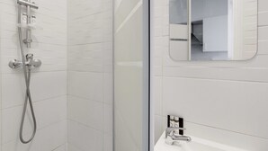 A modern bathroom with a glass shower enclosure, a white tiled wall, and a small mirror above the sink. - Lovely Studio for 2 People - Levallois-perret (Levallois-Perret)