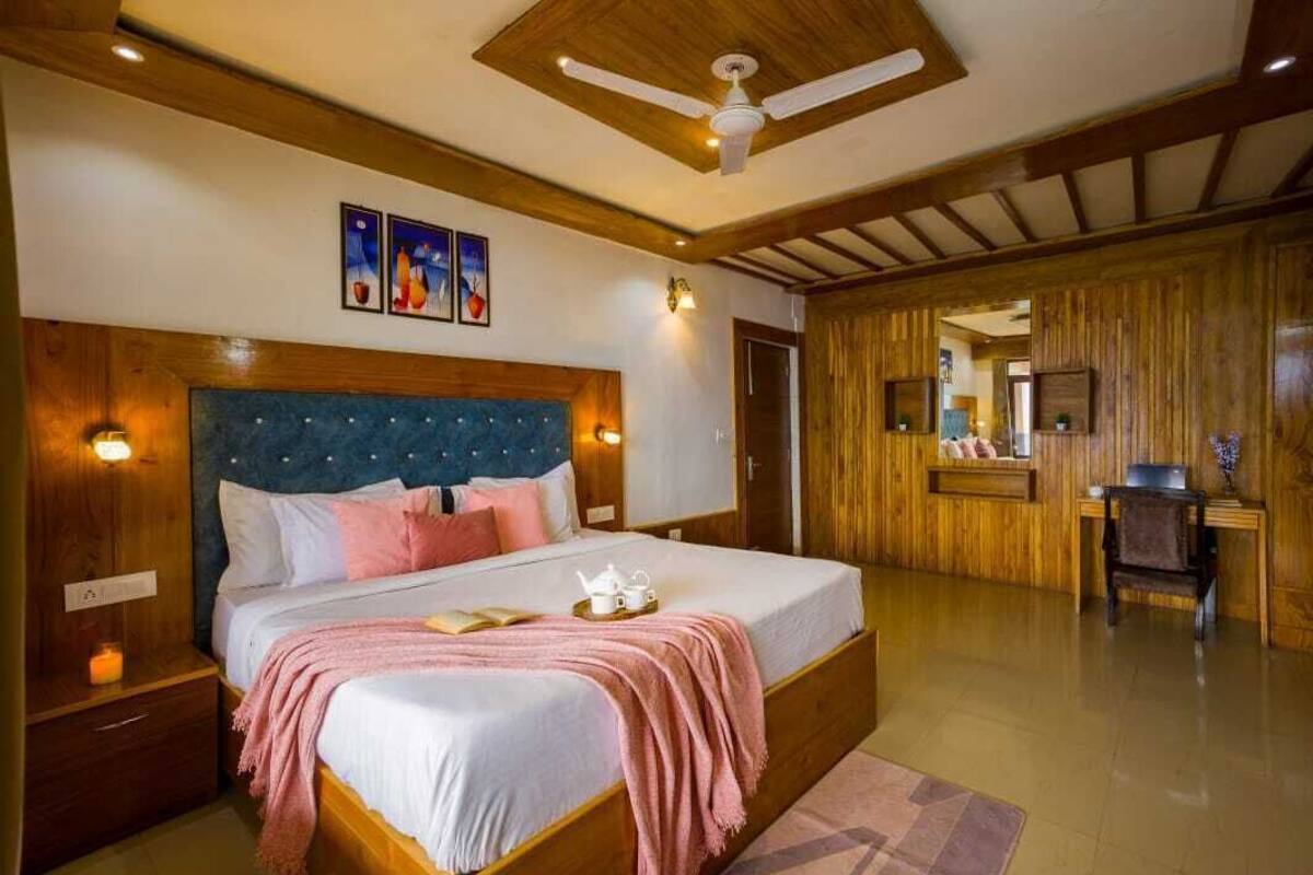A spacious bedroom with a large bed, wooden headboard, and a ceiling fan.