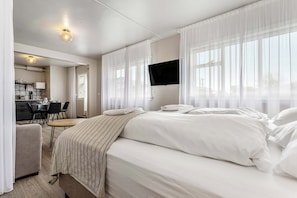 Une chambre d’hôtel avec un lit, un bureau et une chaise.