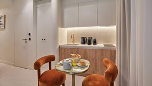 A compact kitchen with a sink, coffee maker, and breakfast items on the counter. - Studio Louvre Museum Palais-royal (Paris)