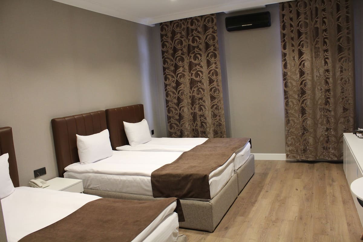 Comfort Triple Room, City View | Free minibar items, in-room safe, desk, laptop workspace