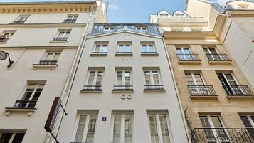 A multi-story building with a classic architectural style, featuring symmetrical windows and balconies.