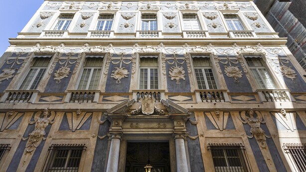 A grand building with classical architecture, featuring ornate carvings, large windows, and a prominent entrance with a decorative archway. - Garibaldi Attic by Wonderful Italy (Genova)