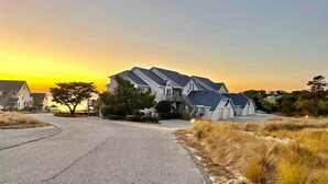 A residential street with houses, a clear sky, and a sunset. - NanDUCKet on the bay in DUCK, NC! (Kitty Hawk)