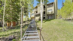 A multi-story building with a metal staircase leading up to the entrance. - Hike, Bike & Fish: Brian Head Resort Condo! (Brian Head)