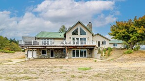 A two-story house with a stone foundation, a green roof, and a balcony. - Vineyard Farmhouse in Oakland w/ Hot Tub! (Oakland)