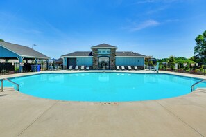 A swimming pool with a stone facade building in the background.
