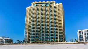 A tall, multi-story hotel with a uniform facade and balconies. - Phoenix West Condominiums (Orange Beach)