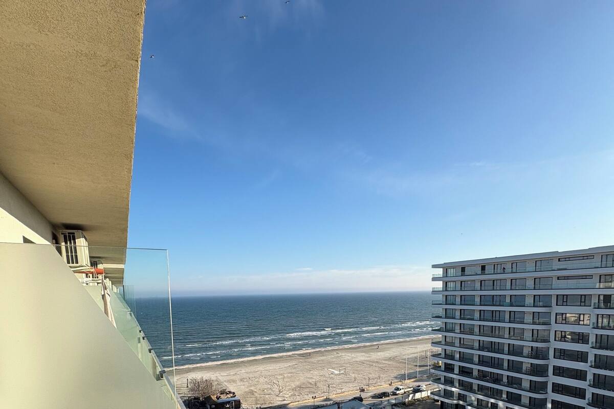 A view from a balcony overlooking a beach and a construction site.