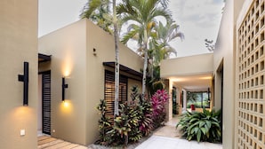 A modern outdoor area with a pathway, palm trees, and various plants. - w Splendid 5BR Villa at Mesa de Yeguas (Anapoima)