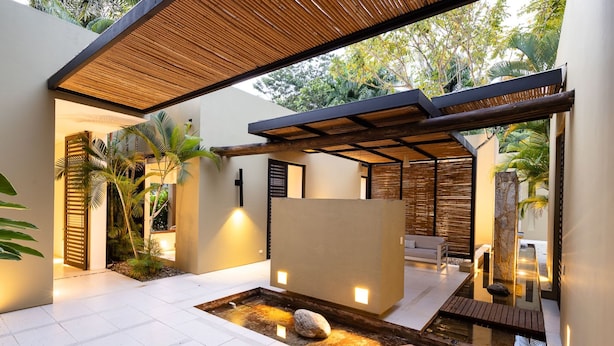 A modern outdoor space with a water feature, seating, and plants. - w Splendid 5BR Villa at Mesa de Yeguas (Anapoima)