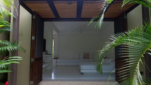 Una sala de estar moderna con un sofá blanco y un ventilador de techo.