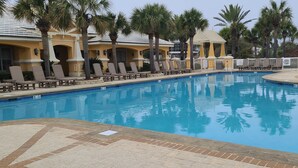 A swimming pool with lounge chairs and palm trees. - Casa Del Mar - Beautiful New Rental (Gulf Shores)
