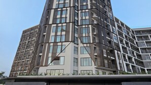 A modern high-rise building with a prominent entrance and a sign reading "LOXWOOD HOUSE". - Loxwood House (Accra)