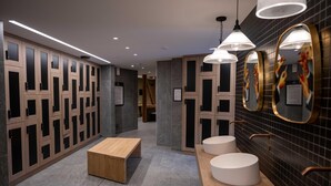 A modern bathroom with wooden lockers, a wooden bench, and three round sinks with mirrors. - Charming Apt With View 2bd/6p -residence in Mega\"ve (Megeve)