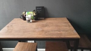A wooden table with a glass and a box of tissues. - Sunny Seaside Apartment in Blackpool (Blackpool)