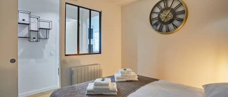 Laptop workspace, iron/ironing board, bed sheets