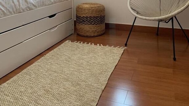 A bedroom with a bed, a chair, a small round table, and two windows. - CT 354 AL - Casa Piedra (Nijar)