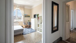 Una habitación de hotel moderna con cama, escritorio y vistas a la ciudad.