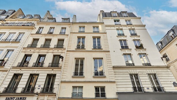 A row of classic Parisian buildings with uniform architectural style, featuring balconies and large windows. - Superb New Apartement Le Marais Place des Vosges (Paris)