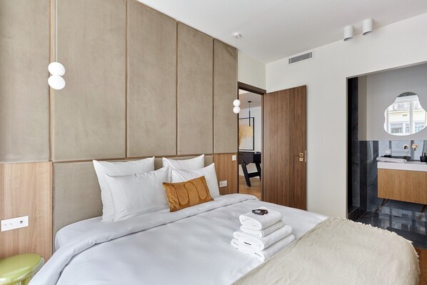 A modern hotel room with a large bed, a wooden headboard, and a view of the city through a window. - Exceptional Apartment With AC - Heart of Paris (Paris)