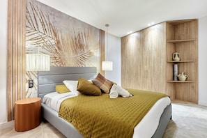 A modern bedroom with a large bed, a wooden wardrobe, and a wall-mounted shelf. - Superb Apartment Center of Paris Montmartre (Paris)