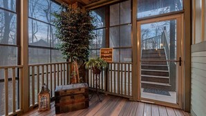 A wooden deck with a staircase, a potted plant, and a vintage trunk. - Juniper Presents: Lodge Retreat w Hot Tub,Firepit,Foosball,BBQ&POOL (New Buffalo)