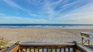 A wooden deck leading to a beach with a clear view of the ocean and a sandy shore. - Buccaneers Bounty: Your Oceanfront Treasure Awaits (North Topsail Beach)