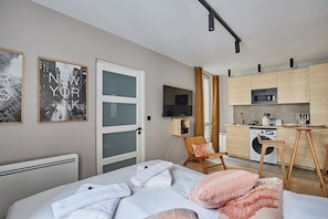 Laptop workspace, iron/ironing board, bed sheets