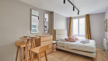 Laptop workspace, iron/ironing board, bed sheets