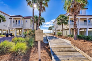 A boardwalk leading to a resort with a sign indicating it is for guests only and prohibiting fireworks. - Beach Music - Community Pool, Beach Front, Pet Friendly! (St George Island)