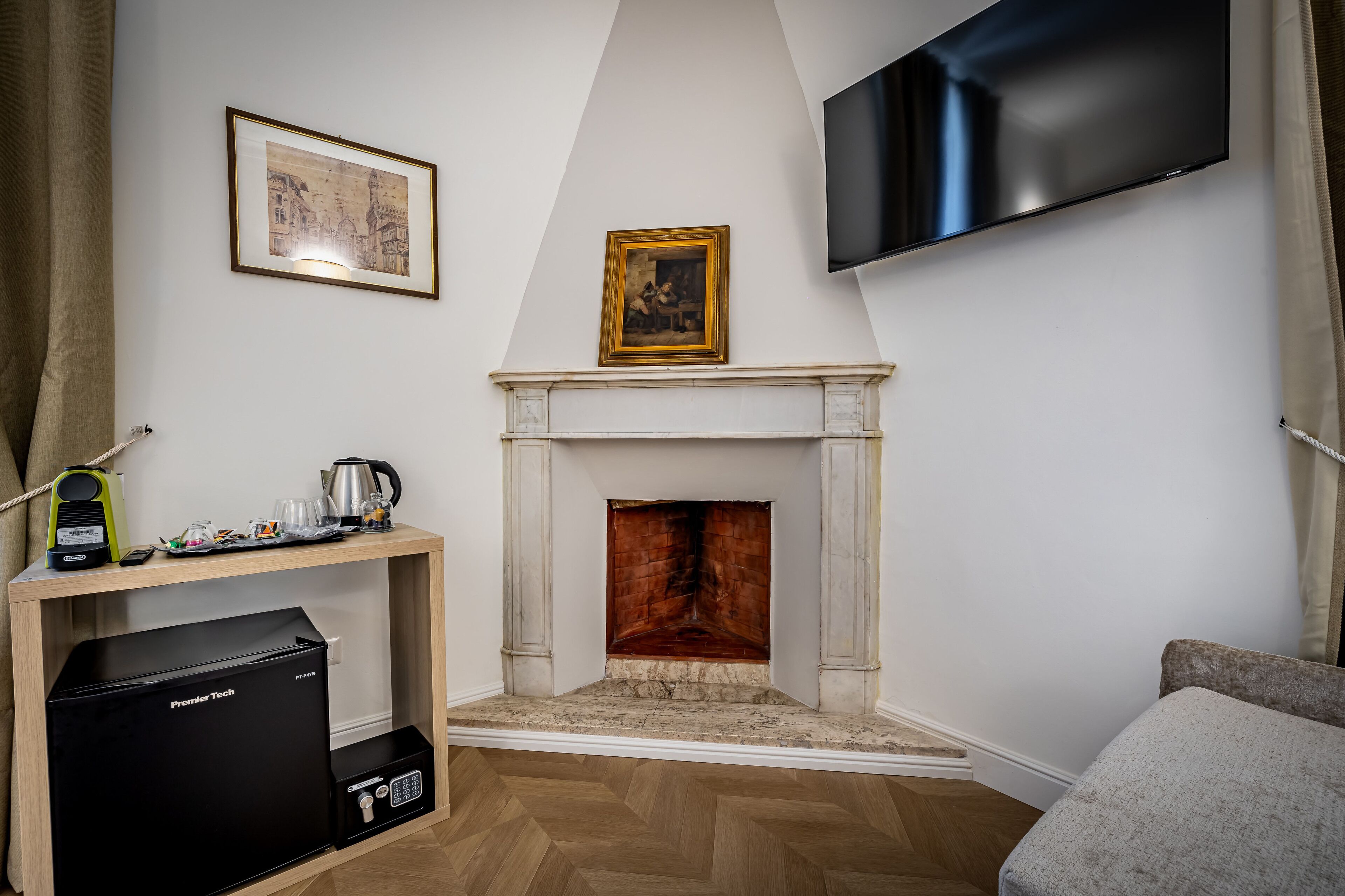 A living room with a fireplace, a mounted TV, and a Pioneer Tech appliance.
